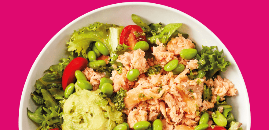picture of a salad on a pink rubine background with "guess who's back?" written in white