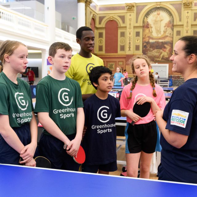 Young people being coached table tennis